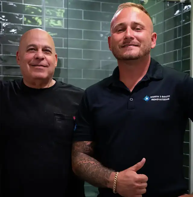 Colby Matheny of North2South Renovations with a team member in front of a green subway tile shower